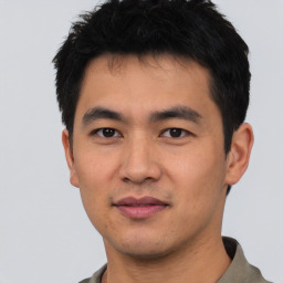 Joyful asian young-adult male with short  black hair and brown eyes