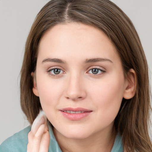 Joyful white young-adult female with long  brown hair and grey eyes