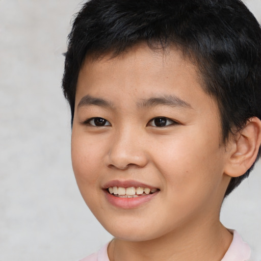 Joyful asian child male with short  brown hair and brown eyes