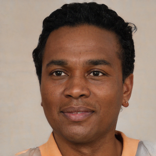 Joyful black young-adult male with short  black hair and brown eyes