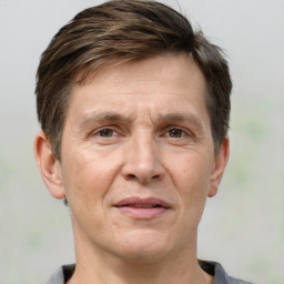 Joyful white adult male with short  brown hair and grey eyes