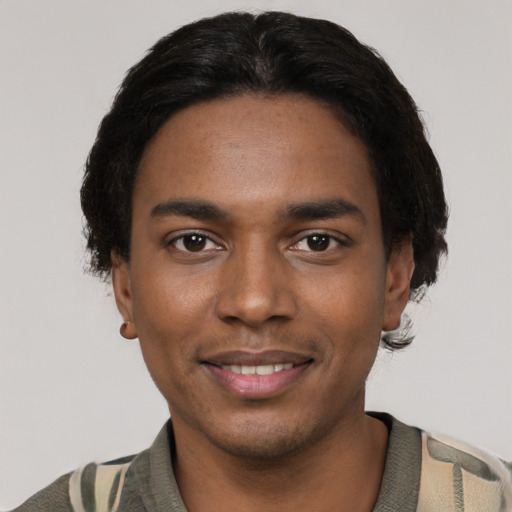 Joyful black young-adult male with short  black hair and brown eyes