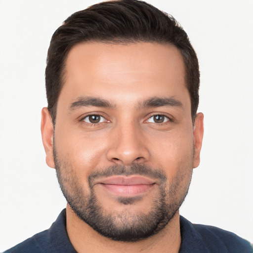 Joyful white young-adult male with short  black hair and brown eyes