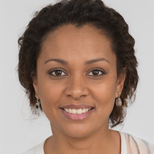 Joyful black young-adult female with short  brown hair and brown eyes