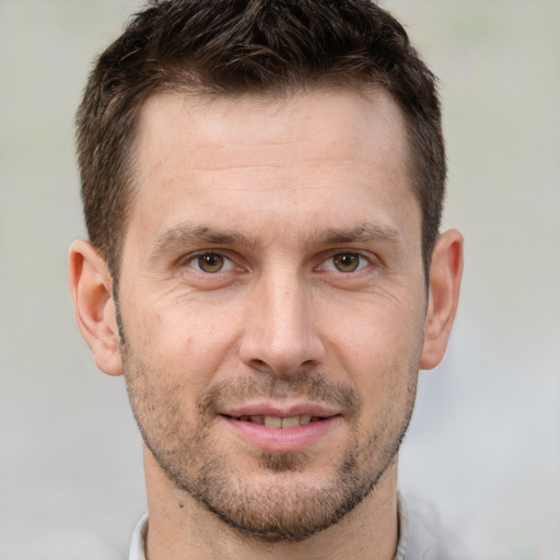 Joyful white adult male with short  brown hair and brown eyes