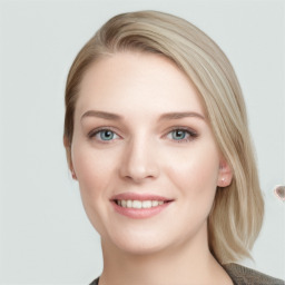 Joyful white young-adult female with long  brown hair and blue eyes