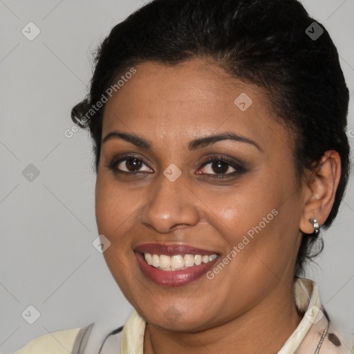 Joyful latino young-adult female with short  brown hair and brown eyes