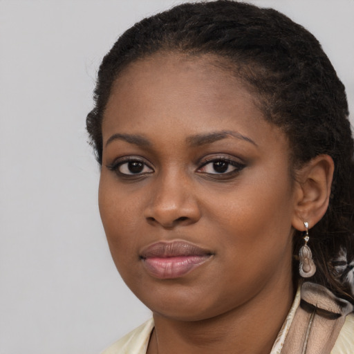 Joyful black young-adult female with long  brown hair and brown eyes