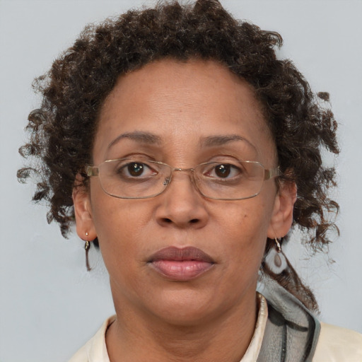 Joyful black adult female with short  brown hair and brown eyes