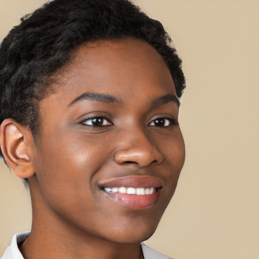 Joyful black young-adult female with short  brown hair and brown eyes