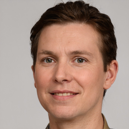 Joyful white adult male with short  brown hair and grey eyes