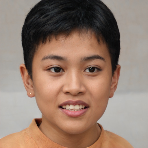 Joyful asian child male with short  brown hair and brown eyes