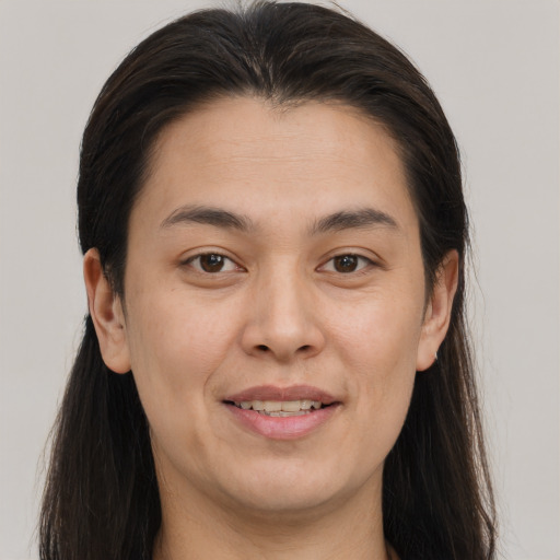 Joyful white young-adult female with long  brown hair and brown eyes