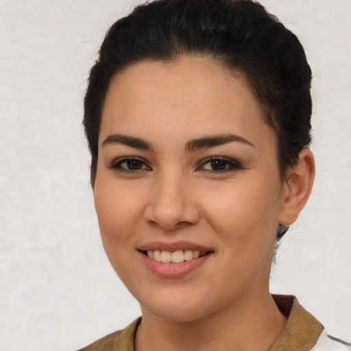 Joyful latino young-adult female with short  brown hair and brown eyes