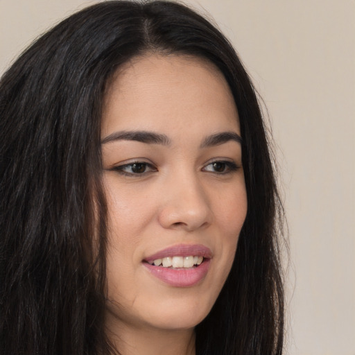 Joyful asian young-adult female with long  brown hair and brown eyes