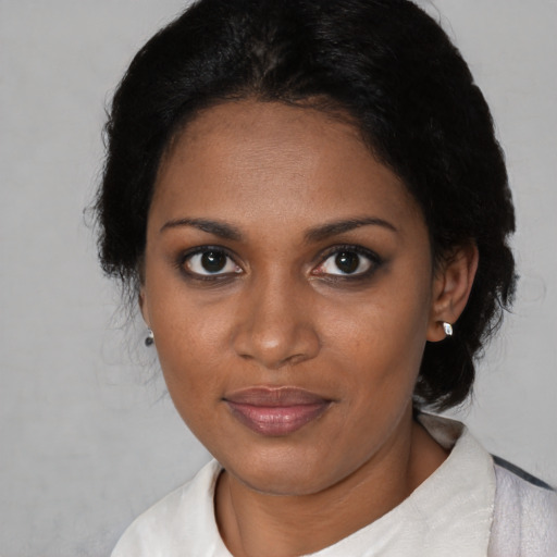 Joyful black adult female with short  brown hair and brown eyes