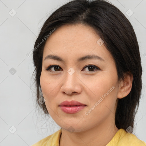 Joyful asian young-adult female with medium  brown hair and brown eyes