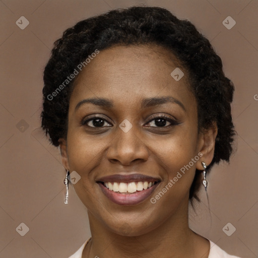 Joyful black young-adult female with long  brown hair and brown eyes