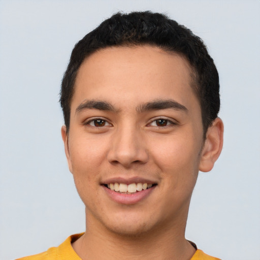 Joyful latino young-adult male with short  brown hair and brown eyes