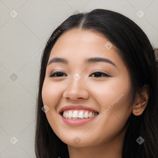 Joyful latino young-adult female with long  black hair and brown eyes