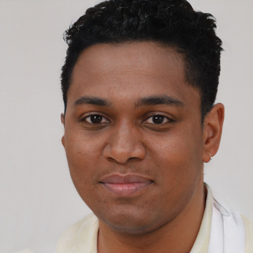 Joyful black young-adult male with short  black hair and brown eyes