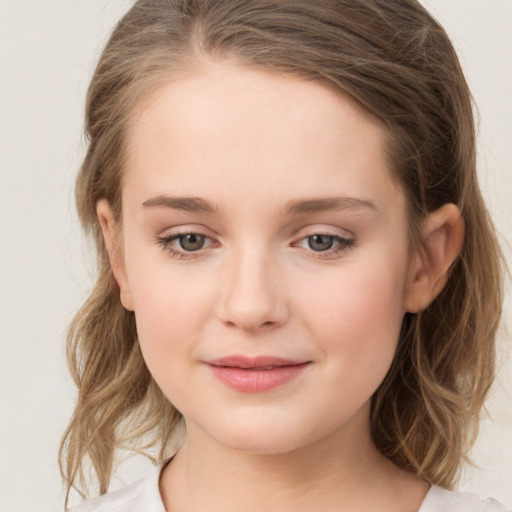 Joyful white child female with medium  brown hair and grey eyes