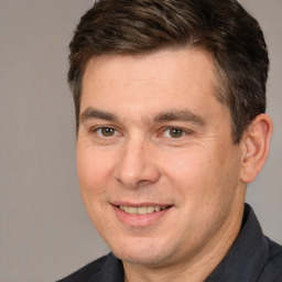 Joyful white adult male with short  brown hair and brown eyes