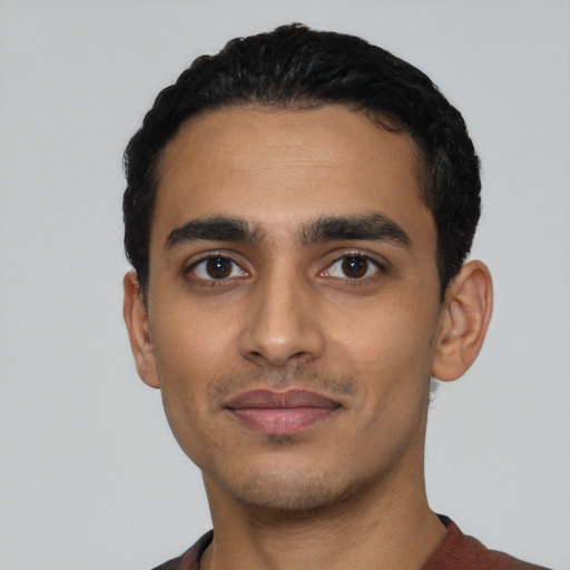 Joyful latino young-adult male with short  black hair and brown eyes