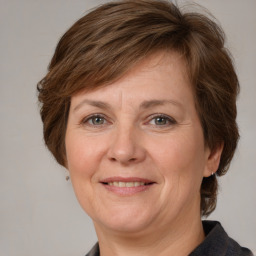 Joyful white adult female with medium  brown hair and grey eyes