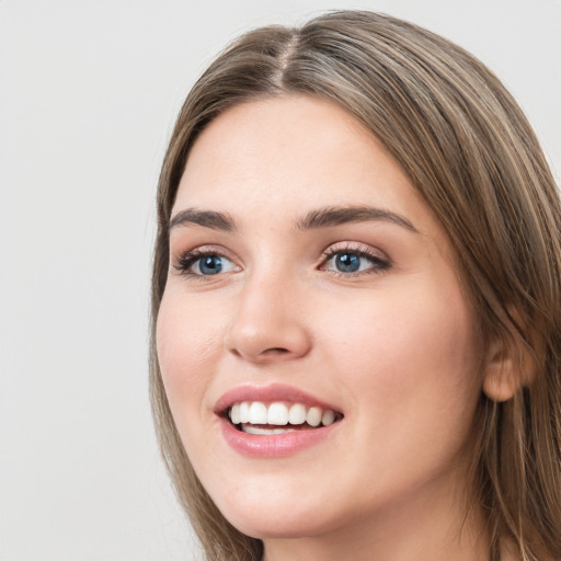 Joyful white young-adult female with long  brown hair and grey eyes