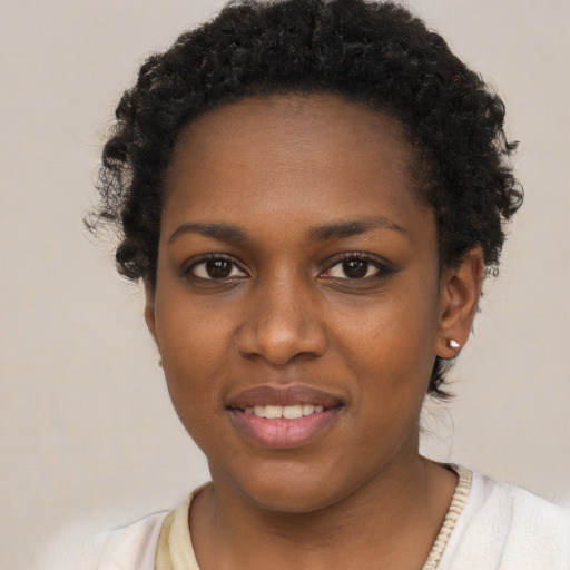 Joyful black young-adult female with short  brown hair and brown eyes