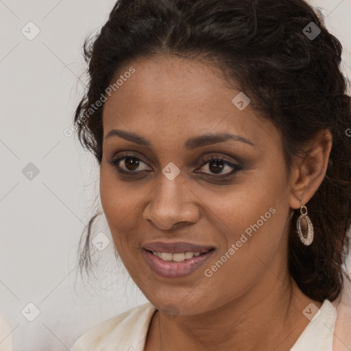 Joyful black young-adult female with long  brown hair and brown eyes