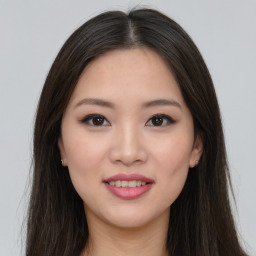 Joyful asian young-adult female with long  brown hair and brown eyes