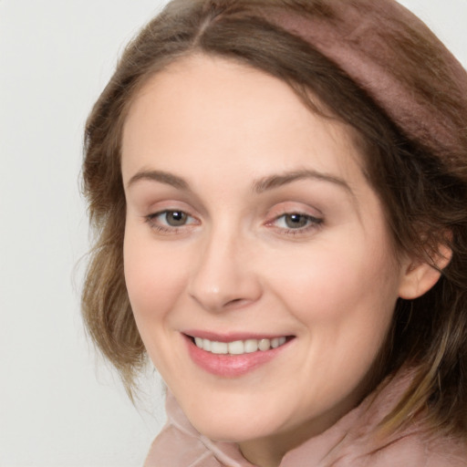 Joyful white young-adult female with medium  brown hair and grey eyes