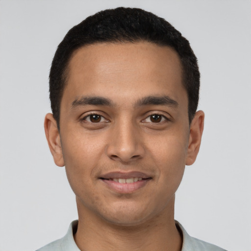 Joyful latino young-adult male with short  black hair and brown eyes