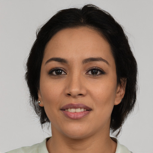 Joyful latino young-adult female with medium  brown hair and brown eyes