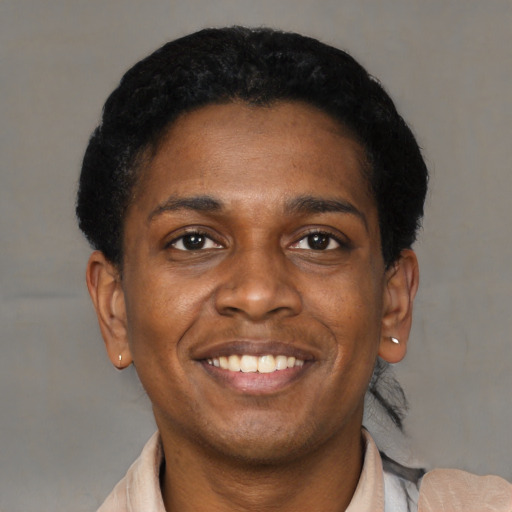 Joyful black young-adult male with short  black hair and brown eyes