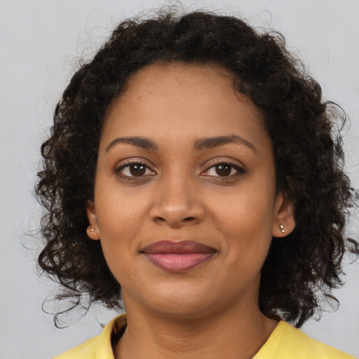Joyful black young-adult female with medium  brown hair and brown eyes
