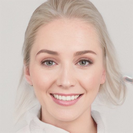 Joyful white young-adult female with medium  blond hair and blue eyes