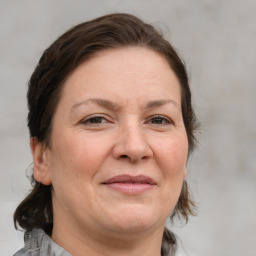 Joyful white adult female with medium  brown hair and grey eyes