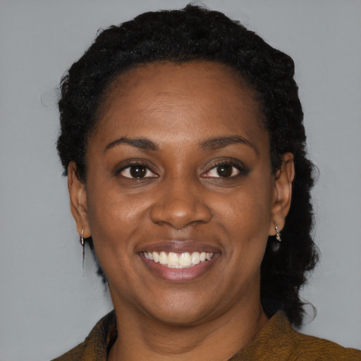 Joyful black young-adult female with medium  black hair and brown eyes