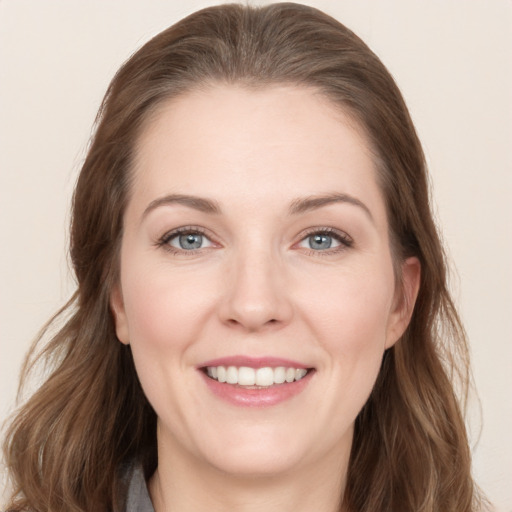 Joyful white young-adult female with long  brown hair and grey eyes