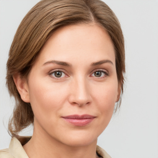 Joyful white young-adult female with medium  brown hair and green eyes