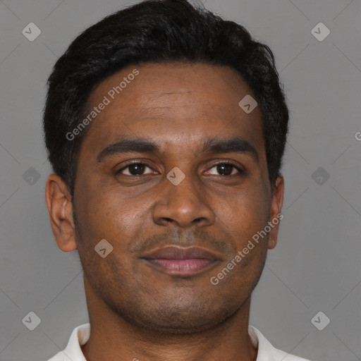 Joyful black young-adult male with short  brown hair and brown eyes