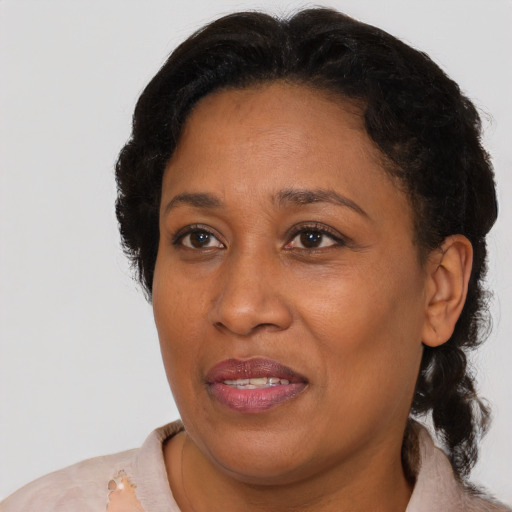 Joyful black adult female with short  brown hair and brown eyes