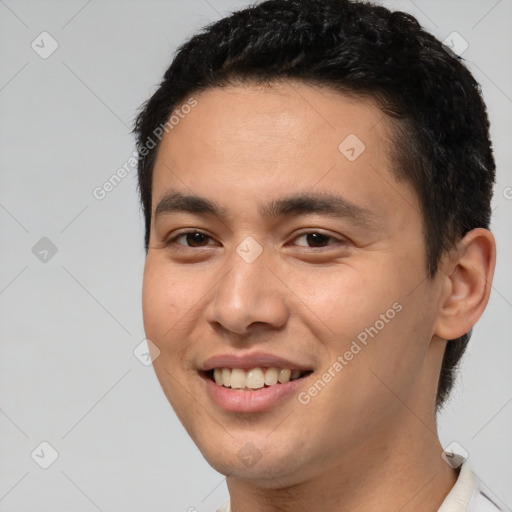 Joyful white young-adult male with short  black hair and brown eyes