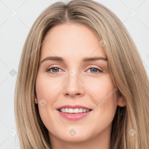 Joyful white young-adult female with long  brown hair and brown eyes