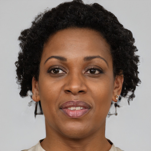 Joyful black adult female with short  brown hair and brown eyes