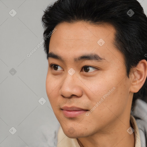 Joyful asian young-adult male with short  black hair and brown eyes