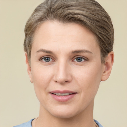 Joyful white young-adult female with short  brown hair and grey eyes